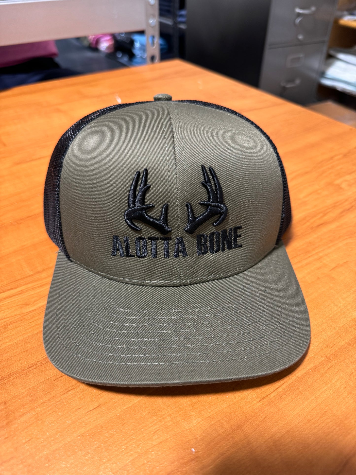 Alotta Bone Embroidered Trucker Hat- Hunter Green/ Black